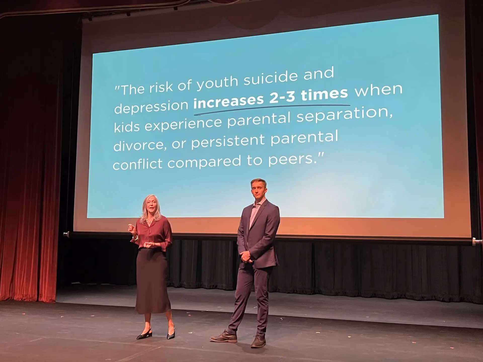 Kerry Stutzman, LMFT and Palmer Skudneski, LMFC speaking at a large conference.